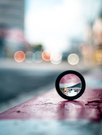Close-up of magnifying glass on road