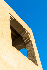 Low angle view of building against clear blue sky