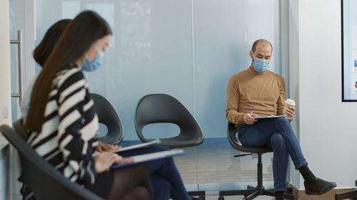 Side view of young man working in meeting