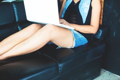 Low section of woman sitting on seat