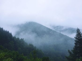 Scenic view of mountains against cloudy sky