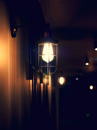 Close-up of illuminated pendant light hanging from ceiling