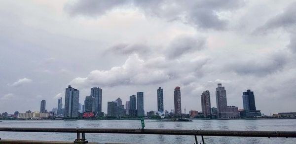 Panoramic view of river and buildings against sky