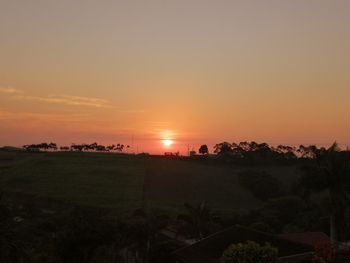 Scenic view of field against sky during sunset