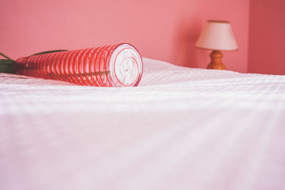 Close-up of electric lamp on bed at home