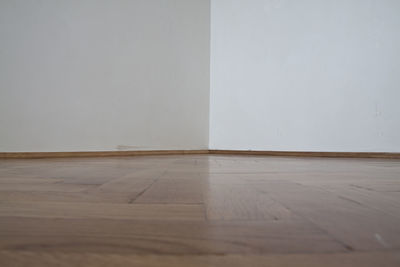 Surface level of wooden floor against wall