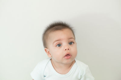 Portrait of cute baby against white background