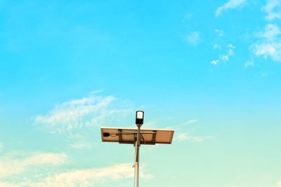 Low angle view of street light against blue sky