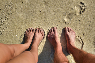 Low section of feet on sand