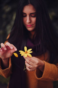 Close-up of woman holding flower