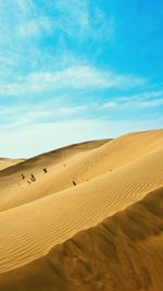 Scenic view of desert against blue sky