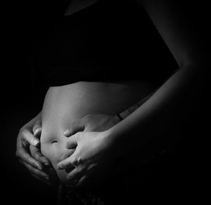 Close-up of woman sleeping against black background