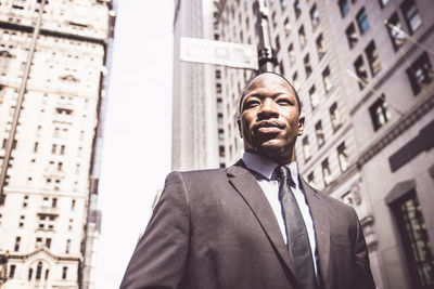 Low angle view of man standing in front of buildings