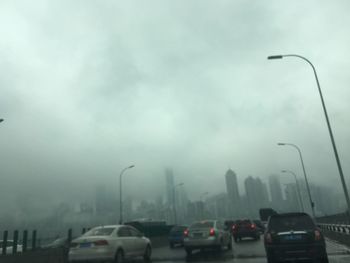 Vehicles on road against the sky