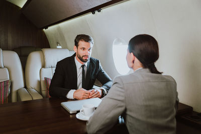 Business people sitting in airplane