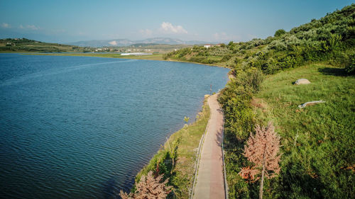 Panoramic shot of road by sea against sky