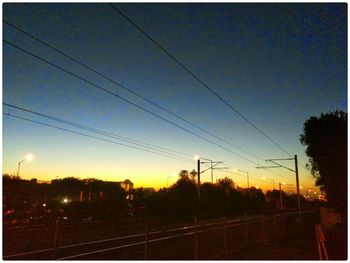Silhouette of trees against sky at sunset