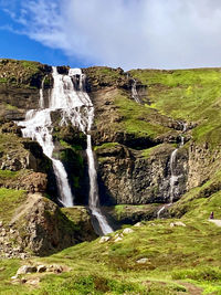 Scenic view of waterfall against sky