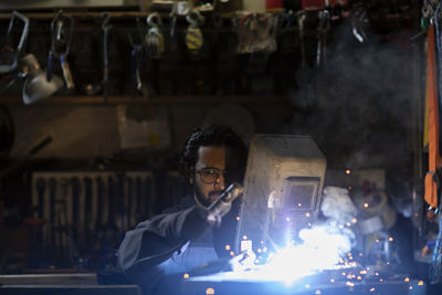 Young welder technician working in workshop