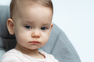 Close-up of cute baby boy against white background