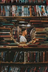 Full length of man reading book in library