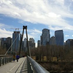 Buildings in city against cloudy sky