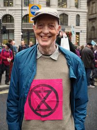 Portrait of smiling man standing on street in city