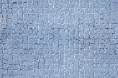 Full frame shot of blue uneven wall with small  tiles