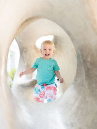 High angle view of girl standing in tunnel