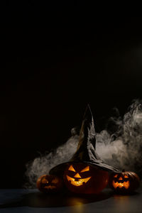 Close-up of illuminated pumpkin against black background