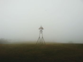 Windmill on field against sky