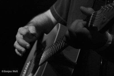 Close-up of man playing guitar