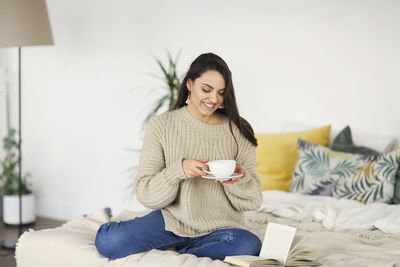 Young woman drinking coffee at home