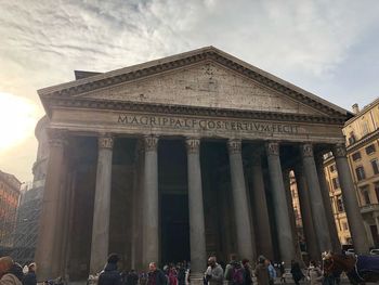 Low angle view of historical building against cloudy sky