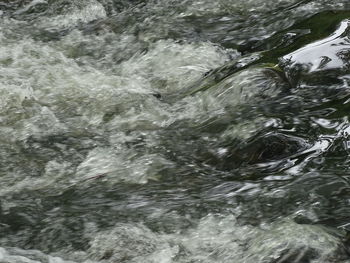 High angle view of water flowing in sea