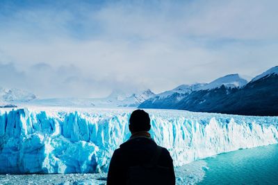 Rear view of man looking at glacier from observation point