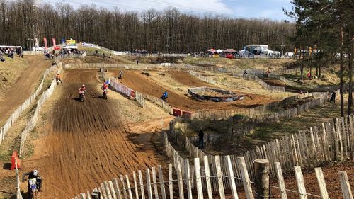 High angle view of riders riding motorcycles on dirt road during sports race