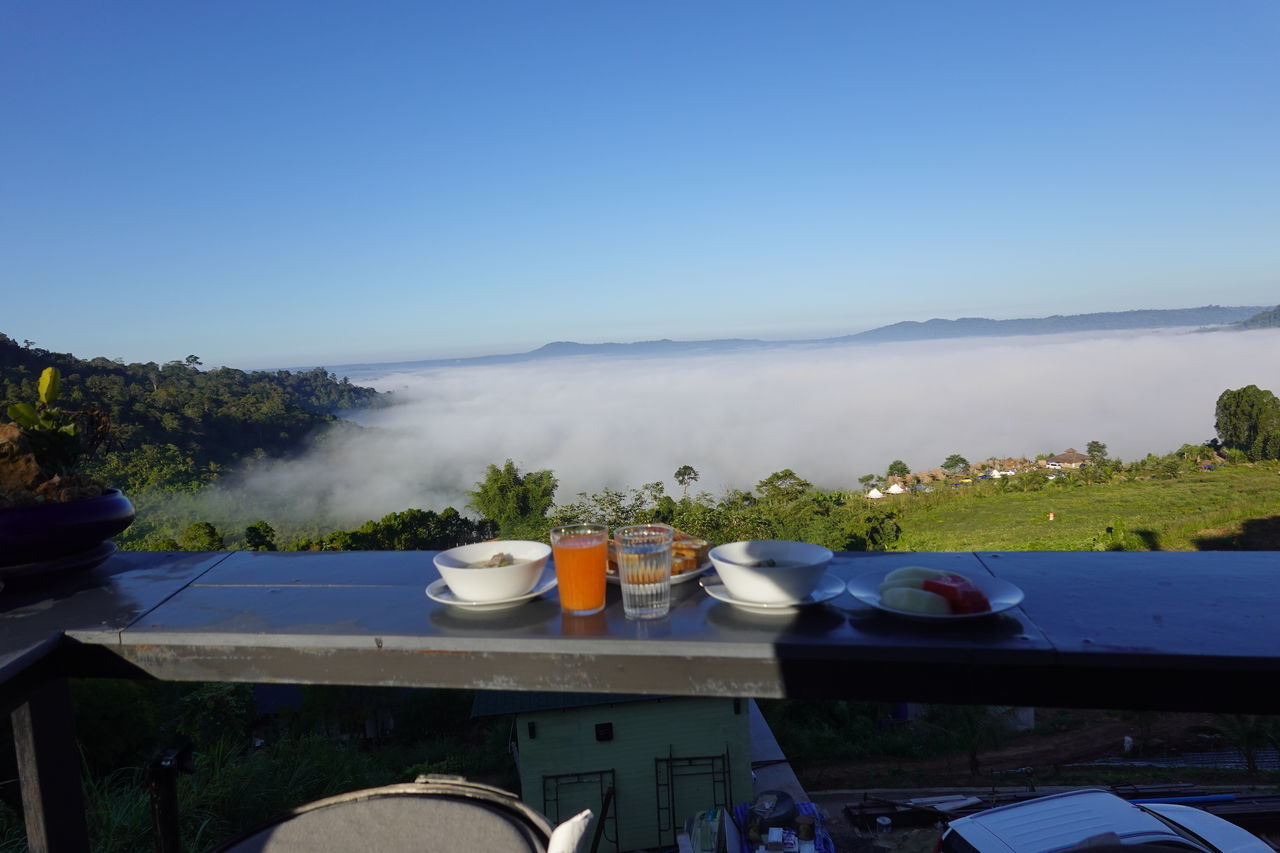 HIGH ANGLE VIEW OF FOOD ON TABLE AGAINST BLUE SKY