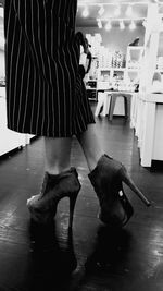 Low section of woman standing in kitchen