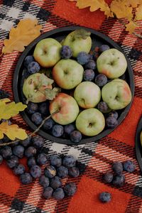 High angle view of grapes in bowl on table