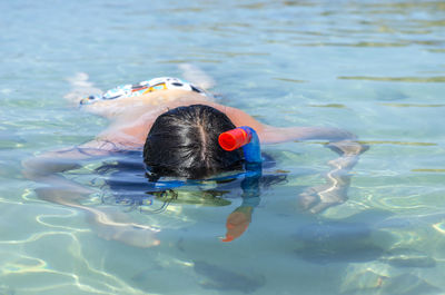 High angle view of woman snorkeling in sea