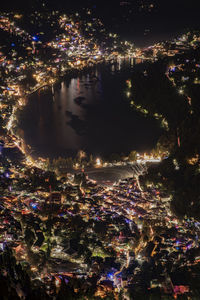 High angle view of illuminated city lit up at night