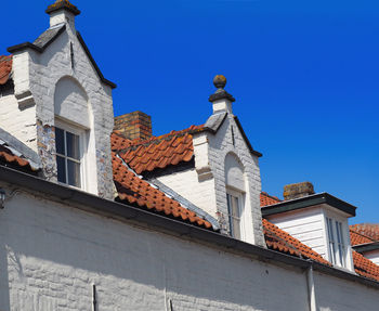 Low angle view of building against clear blue sky