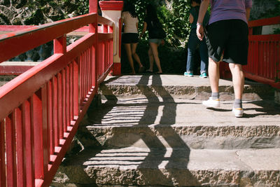 Rear view of people walking on staircase