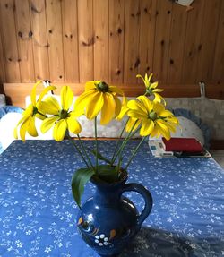 Close-up of yellow flowers in vase on table