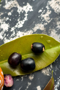 High angle view of fruits and leaves on table