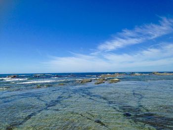 Scenic view of sea against blue sky