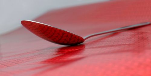 Close-up of red leaf on table