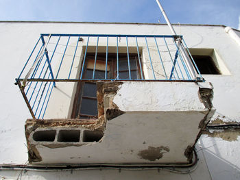 Low angle view of abandoned building against sky