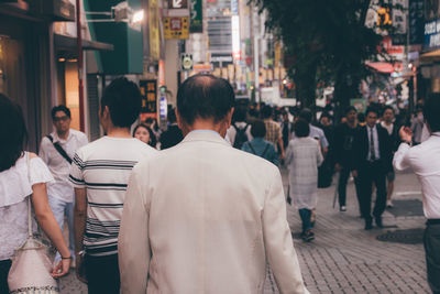 People on walking on street in city at dusk